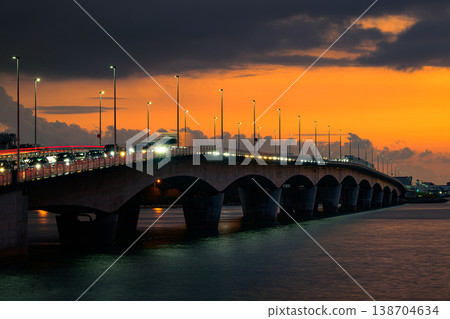 Kameezhi Bridge: A bridge spanning the sky and sea, bathed in the colors of the sunset. Kameezhi Bridge: A bridge spanning the sky and sea, bathed in the colors of the sunset. 138704634