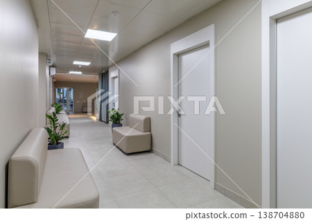 Long Clinic Hallway with White Doors and Waiting Area Long Clinic Hallway with White Doors and Waiting Area 138704880