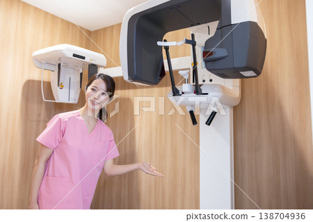 Dental X-ray image; Nurse preparing the X-ray equipment. 138704936