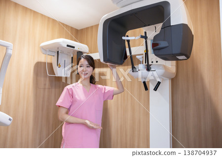 Dental X-ray image; Nurse preparing the X-ray equipment. 138704937