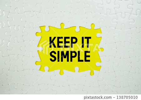 Jigsaw puzzle with a missing piece with "Keep It Simple" on yellow background 138705010
