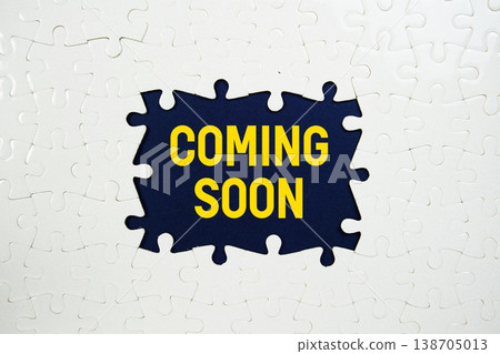 Jigsaw puzzle with a missing piece with "Coming Soon" on blue background 138705013