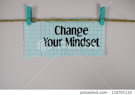 Change Your Mindset text written on rip paper with wooden clip on pink background Change Your Mindset text written on rip paper with wooden clip on pink background 138705120