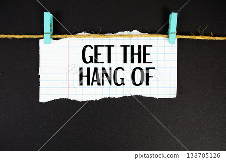 Get The Hang Of text written on rip paper with wooden clip on black background Get The Hang Of text written on rip paper with wooden clip on black background 138705126