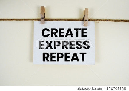 Create Express Repeat text written on paper card with rope and wooden clip hanging Create Express Repeat text written on paper card with rope and wooden clip hanging 138705138