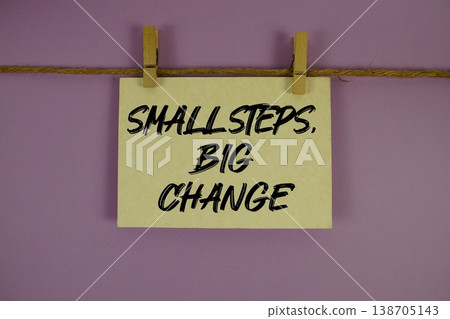 Small Steps, Big Change text written on paper card with rope and wooden clip hanging 138705143