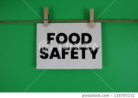 Food Safety text written on paper card with rope and wooden clip hanging Food Safety text written on paper card with rope and wooden clip hanging 138705152