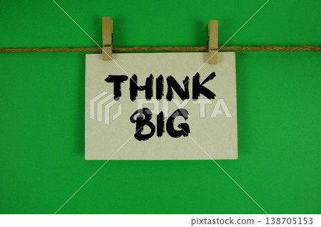 Think Big text written on paper card with rope and wooden clip hanging Think Big text written on paper card with rope and wooden clip hanging 138705153