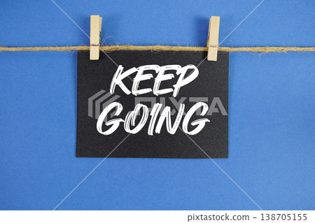 Keep Going text written on paper card with rope and wooden clip hanging Keep Going text written on paper card with rope and wooden clip hanging 138705155