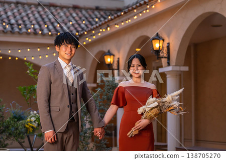 Bride and groom walking through the wedding venue (night wedding, wedding, Asian) Bride and groom walking through the wedding venue (night wedding, wedding, Asian) 138705270