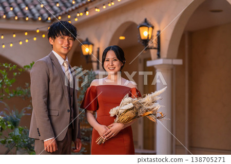 Bride and groom walking through the wedding venue (night wedding, wedding, Asian) Bride and groom walking through the wedding venue (night wedding, wedding, Asian) 138705271