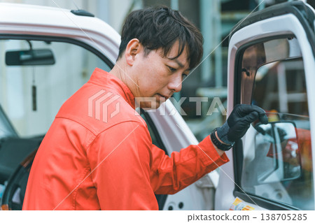 A light truck and a man in overalls A light truck and a man in overalls 138705285