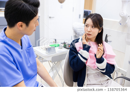 Dentist Patient receiving examination Dentist Patient receiving examination 138705364