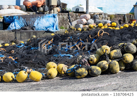 Fishing nets and floats piled up in a fishing port (a scene of fishing) 138706425