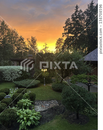 View of the summer garden and the sunset. Country landscape. View of the summer garden and the sunset. Country landscape. 138708596