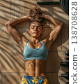Young woman resting on a gym floor after an intense workout session 138708628