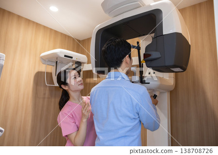 Dental image: A man undergoing an X-ray examination. Dental image: A man undergoing an X-ray examination. 138708726