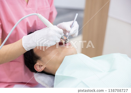 Dentist, patient receiving treatment 138708727