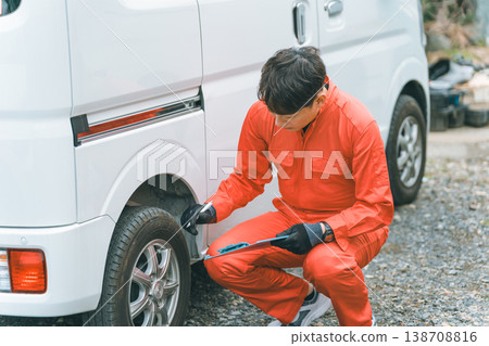 A light van and a man in overalls A light van and a man in overalls 138708816