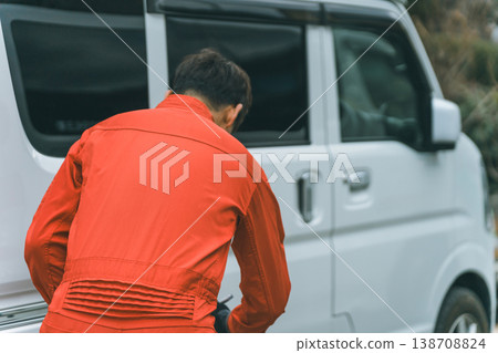 A light van and a man in overalls 138708824