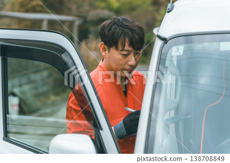 A light commercial vehicle and a man in overalls 138708849