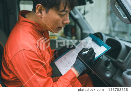 A light van and a man in overalls A light van and a man in overalls 138708858