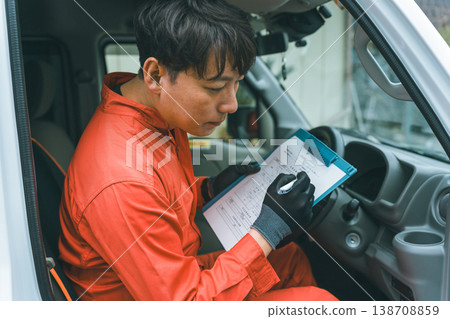一輛輕型貨車和一個穿著工作服的男人 138708859