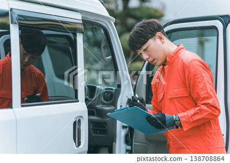 A light van and a man in overalls A light van and a man in overalls 138708864