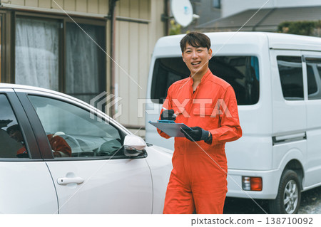 A passenger car and a man in overalls 138710092