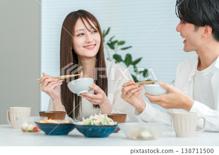Young Asian couple eating at the dining table in their home 138711500