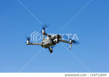 The drone copter flying with digital camera. The drone copter flying with digital camera. 138712609