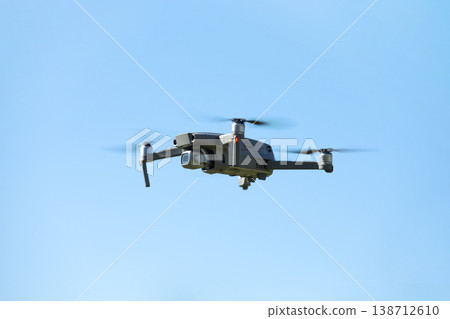 The drone copter flying with digital camera. The drone copter flying with digital camera. 138712610