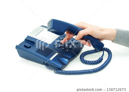 hand holding phone receiver and dialing number hand holding phone receiver and dialing number 138712673