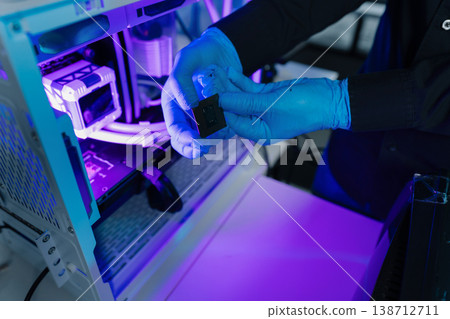 Computer Hardware Technician Repairing Motherboard with Soldering Iron in Electronics Lab. Computer Hardware Technician Repairing Motherboard with Soldering Iron in Electronics Lab. 138712711
