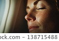 Woman resting by airplane window 138715488