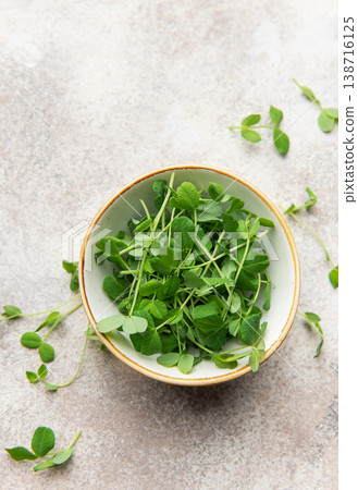 Green pea shoots in bowl, healthy microgreens for fresh eating Green pea shoots in bowl, healthy microgreens for fresh eating 138716125