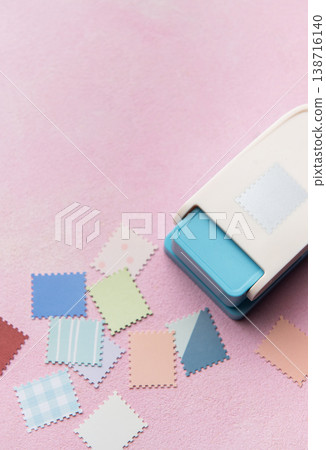 Punching decorative paper shapes for creative scrapbooking craft 138716140