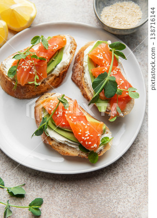 Salmon avocado bruschetta with cream cheese and lemon Salmon avocado bruschetta with cream cheese and lemon 138716144