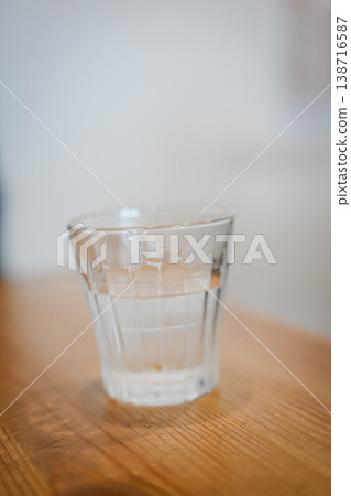A stylish cafe table with a glass of water. A stylish cafe table with a glass of water. 138716587