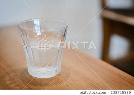 A stylish cafe table with a glass of water. A stylish cafe table with a glass of water. 138716589