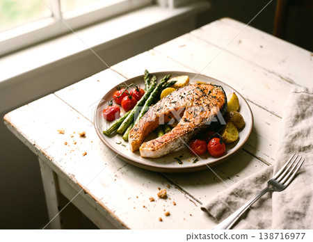 Grilled salmon steak with asparagus, cherry tomatoes, and baby potatoes on a rustic wooden table by the window. Grilled salmon steak with asparagus, cherry tomatoes, and baby potatoes on a rustic wooden table by the window. 138716977