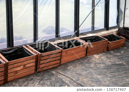 Row of Wooden Planter Boxes With Liner Installed Inside Greenhouse Growing Area 138717407