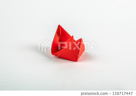 Single Red Origami Paper Boat on Minimal Light Background Single Red Origami Paper Boat on Minimal Light Background 138717447