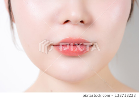 Close-up of a woman's lips with natural makeup: beauty skincare, translucent lip gloss and lip care. Close-up of a woman's lips with natural makeup: beauty skincare, translucent lip gloss and lip care. 138718228