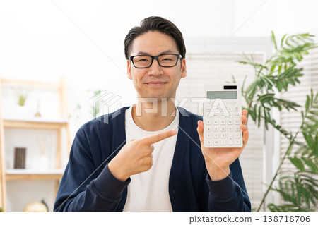 Man with calculator, pointing Man with calculator, pointing 138718706