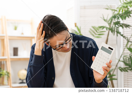 A man with a calculator is troubled. A man with a calculator is troubled. 138718712