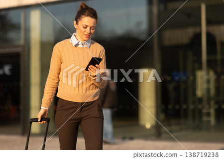 Connected Traveler Walking Through Modern Transit Hub Connected Traveler Walking Through Modern Transit Hub 138719238