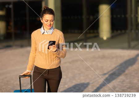 Connected Traveler Checking Train Schedule on Smartphone Connected Traveler Checking Train Schedule on Smartphone 138719239