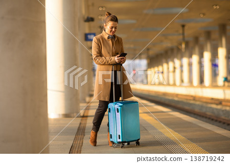 Female Traveler Checking Train Schedule on Smartphone Female Traveler Checking Train Schedule on Smartphone 138719242