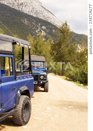 Land rover defenders parked on dirt road, exploring mountains Land rover defenders parked on dirt road, exploring mountains 138719277